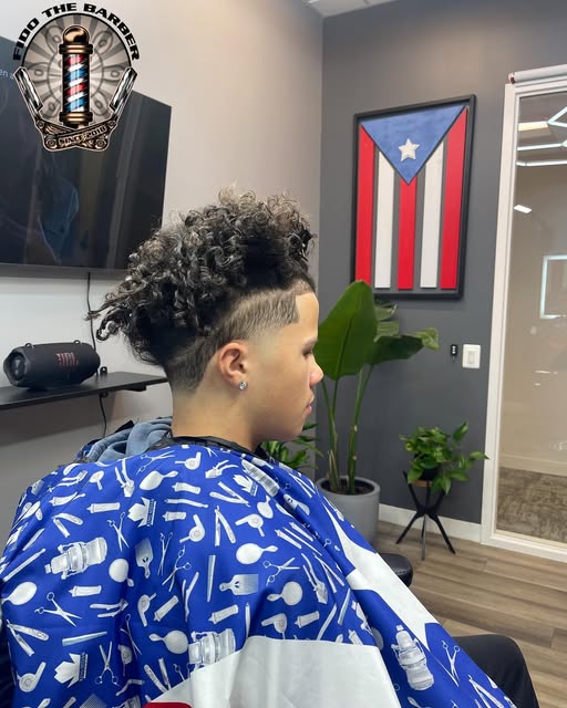Curly top haircut with cleanly tapered sides and a sharp hairline
