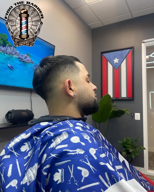 Side view of a finished haircut with a smooth fade and shaped beard